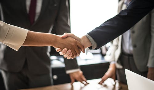 A photo of a man and a woman shaking hands