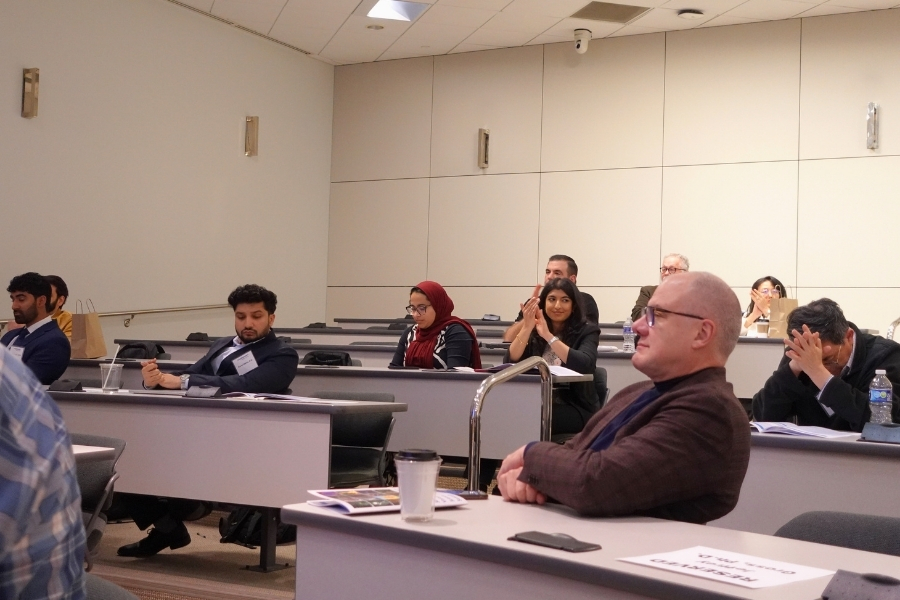Seated conference attendees in a lecture hall