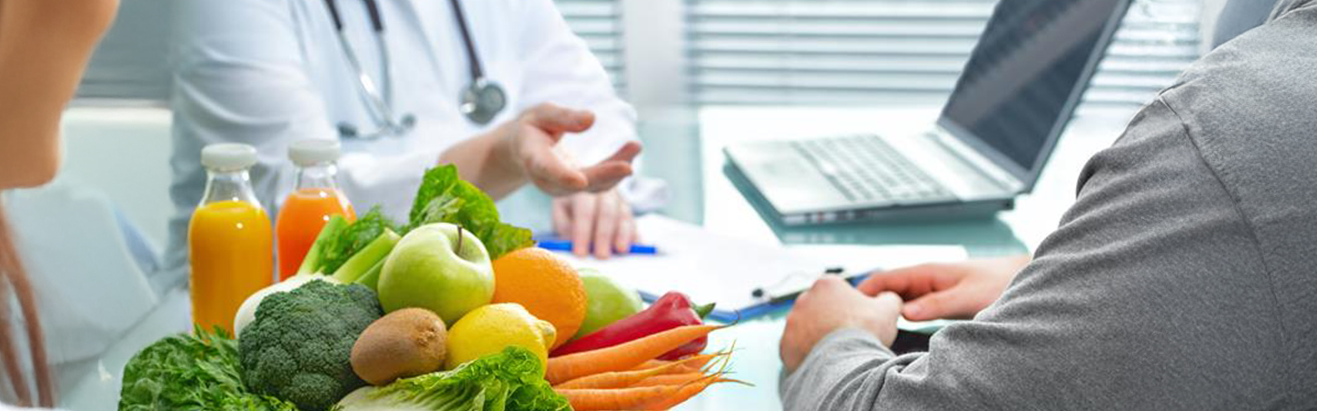 Bowl of fruits and vegetables on desk in doctor's office.