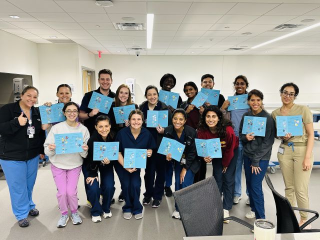 Group of medical students holding cards