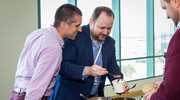 Office of Development and Alumni Relations colleagues Tanner Garrett, left, and Dallas Guill enjoy adding candy toppings to their ice cream sundaes at the Institutional Advancement celebration.