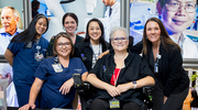 Volunteers from the Employee Advisory Council pause for a photo op in between assisting with the Health System ceremony.