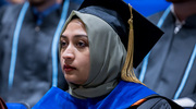 Laiba Husain, Ph.D., M.P.H., Assistant Professor of Social and Behavioral Sciences, watches as the graduates cross the stage.