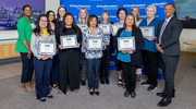 Eleven Gold PACT pin recipients proudly gather for a group photo at the Institutional Advancement event. The recipients include, front row from left: Sherleen Mahoney and Adrienne Long of CMPA and Yolanda Dominguez and Rebecca Cardiel of Advancement Strategy and Operations; and back, starting second from left: Ms. Naraine, Ms. Anderson, and Kristen Koerner of CMPA; Laurie Hamilton of Advancement Strategy and Operations; Danielle Forrester of Information Resources; and Paige Poletes and Kim Perkins of CMPA. Leaders joining in include, at left, Shashea L. Adams-Guess, M.B.A., Associate Vice President of Advancement Strategy and Operations, and at right, Marc Nivet, Ed.D., M.B.A., Executive Vice President for Institutional Advancement and Interim Executive Vice President for Business Affairs.