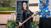 Maralice Conacci-Sorrell, Ph.D., Associate Professor of Cell Biology and in the Children’s Medical Center Research Institute at UT&nbsp;Southwestern, holds the Stembridge Mace she carried during the academic procession. The symbol represents the torch of learning and passing of knowledge from teacher to student over generations.