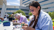 Chamisa Piechowski-Begay, right, and Roland Brunette of the First Nations Intertribal Alliance BRG demonstrate craft-making.