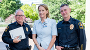 Emily Flahaven,&nbsp;M.S.N., RN, Associate Vice President and Chief Nursing Informatics Officer, enjoyed the post-ceremony reception with Chief Marcus Lewis,&nbsp;M.A., left, and Assistant Chief Pete Amaral of the UTSW Police Department.