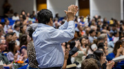 Proud family members give their graduate a standing ovation.