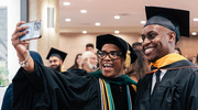 Temple Howell-Stampley, M.D., M.B.A., Chair and Program Director of the Department of Physician Assistant Studies, and Master of Physician Assistant Studies graduate Samuel Anene relish the exiting moment.