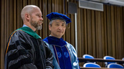Jonathan Reeder, M.D., Program Director, Master of Science in Health Informatics, OSPH (left), and Joseph Su, Ph.D., M.P.H, Associate Dean for Academic Affairs, OSPH, wait for the festivities to begin as they prepare to watch their graduates cross the stage.