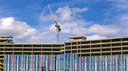 The final beam is lifted by a crane to be installed atop Moody Children’s Hospital, which is slated to open in 2031.