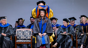 Neuroscience graduate Daniela Barbosa, Ph.D., receives her hood from Lu Sun, Ph.D., Assistant Professor of Molecular Biology.