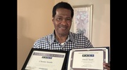 Facilities Management’s Chester Smith displays his Platinum and Gold pin certificates