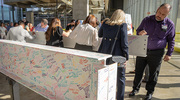 Employees and supporters sign one of the hospital beams at the event.