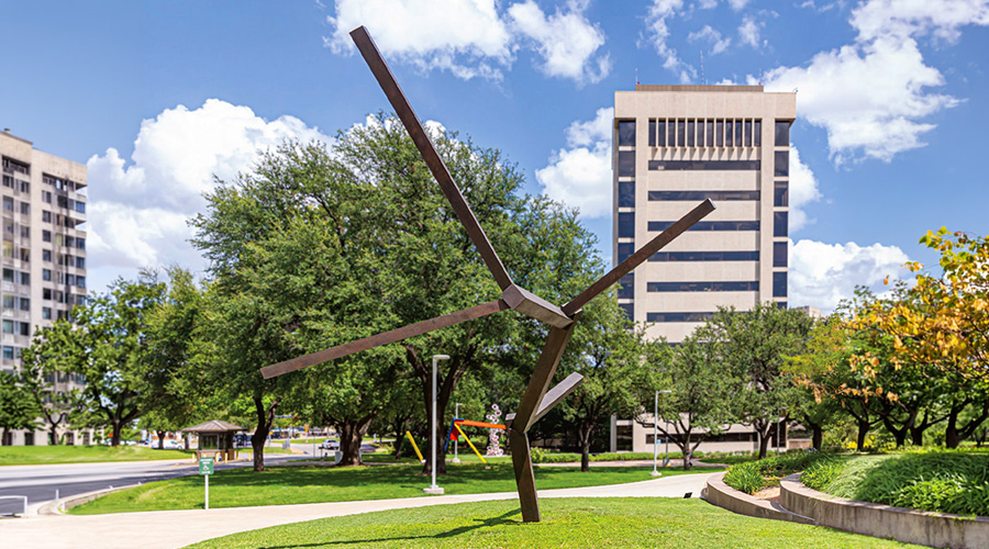 Large statue of twisted metal beams.