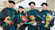 Flowers and celebratory stuffed animals mark the occasion for grads (from left) Roberto Gonzalez, M.D., Margaret McGurn, M.D., Felipe Gonzalez Gutierrez, M.D., and Karim Salhadar, M.D.