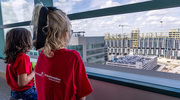 At the event, pediatric patients look out a window to view the new hospital under construction.