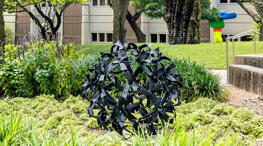 An outdoor statue of a bronze thistle.