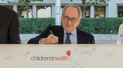 Dr. Podolsky pens his signature to mark the historic occasion.