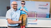 Cameron Strother, M.B.A., Children’s Health Program Director of Risk and Environmental Health and Safety for construction on the New Pediatric Campus, and his son, Finley, celebrate the topping off. At 16 months old, Finley underwent a liver transplant at Children’s Health.