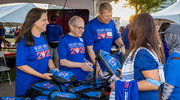UTSW President Daniel K. Podolsky, M.D. (center), hands out exclusive Heart Walk swag.