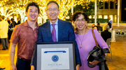 Dr. He attends the post-ceremony reception with wife, Biren and son, HaoWei.