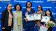 It was a double win for Zaneta McGaughy-Wilson, center, who earned Gold and Platinum pins at the Health System Affairs celebration. At right, Betty Mathai holds her Gold certificate along with a bouquet of flowers. Both are with Patient Financial Services. Standing with them, from left, are supervisors Catherine Giron, Manager of Hospital/Diagnostic Access, and Ladonna Edmondson and Angela Sandoval, both Supervisors of Hospital/Diagnostic Access.