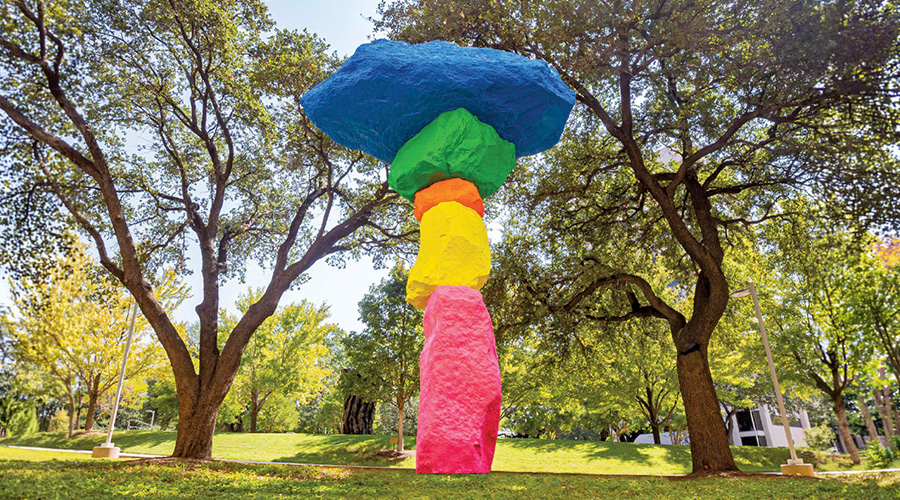 A stack of stones, each painted a different bright color..
