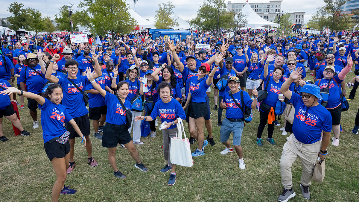Dozens of participants posing in their blue Heart Walk 2025 t-shirts.