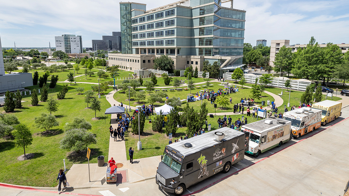 Arial view of campus lawn, visitors, and food trucks.