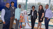 Topping out event attendees from UT Southwestern Facilities Management gather for a photo with the pediatric hospital as a backdrop.