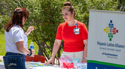 Judith Ramos staffs the Hispanic-Latino Alliance BRG table with games and sweet treats.