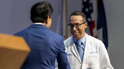Dr. Lee extends a handshake to Gilberto A. Salazar, M.D., FACEP, Professor of Emergency Medicine, who also received a Mentoring Award. “I’m deeply grateful to UT&nbsp;Southwestern for giving me the opportunity to do something that not a lot of people in the world get to do, which is inspire others,” Dr. Salazar told the crowd. “I’m overcome.”