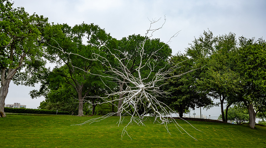 A large silver statue of a neuron.