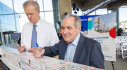 Christopher J. Durovich, President and Chief Executive Officer of Children’s Health (left), and Daniel K. Podolsky, M.D., President of UT Southwestern, sign a beam at the topping out ceremony.