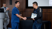Stacy Bautista, RN, of 7 Green (left), accepts his Platinum pin certificate with a smile.