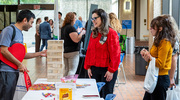 A fair attendee takes on a game of Jenga at the Hispanic-Latino Alliance Business Resource Group’s table.