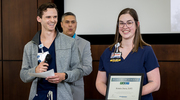 Platinum pin recipient Kristin Davis, PT, D.P.T., (right) is cheered on by Jaron Perry, PT, D.P.T., Assistant Manager, Therapy Services Staff Coordination.
