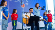 Andrew Koh, M.D., Professor of Pediatrics at UTSW, plays guitar while Suzanne Bouvier, Vice President of Operations for Children’s Medical Center Foundation, and Children’s Health patients sing a song at the celebration.