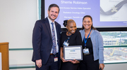 At the Academic Affairs ceremony, Platinum pin recipient Sherrie Robinson from the Radiation Oncology Clinic proudly displays her certificate. Beside her are Cameron Slocum, M.B.A., Vice President and Chief Operating Officer for Academic Affairs and the UTSW Medical Group, left, and Danielle Lynn, Manager of Clinical Operations, Ambulatory Services.