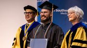 Victor Basil, M.P.H., smiles proudly upon receiving the Alumni Memorial Scholar Award.