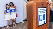 Kimmy Lam, left, and Arushii Nadar, M.D., pose for their Mavs trading card.