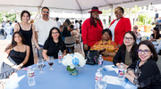 Four members of the Office of Student Financial Aid team, including Ms.&nbsp;Rubi (right), Ms.&nbsp;Truong (next to her), Ms.&nbsp;Ingram (standing at right), and Ms.&nbsp;Cruz (seated, center left), celebrate as they visit with family.