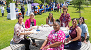 Taking a break around a table, attendees enjoy an afternoon of conversation and celebration.
