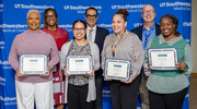 Four Gold pin recipients, all from the Peter O’Donnell Jr. School of Public Health (OSPH), proudly display their certificates at the Academic Affairs event. They include, from left, Glinda McFeders, Breanna Grimes, Nancy Johnson, and Tabatha Joseph. Standing behind, from left, are Margarette Donnay, Manager of Research Programs in OSPH; Saad B. Omer, M.B.B.S., M.P.H., Ph.D., Dean of OSPH; and George Jackson, P.h.D., M.H.A., Interim Chair and Professor of Health Economics, Systems, and Policy in OSPH.