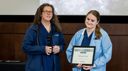 OR Manager Carrie Pritchard honors Platinum pin recipient Mackenzie Ewing (right).