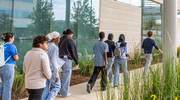 Harmony Science Academy students move from the Structure and Function of ECM outdoor learning station to the indoor Discover the Mysteries of the Brain station.