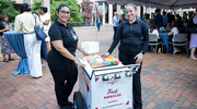 Betsy Leal De Lopez, left, and Beatriz Corrales serve frozen fruit pops to many of the guests.