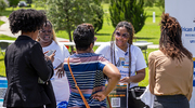 Attendees stop by to pick up swag and other goodies at the African American Alliance BRG table.