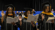 Josepha Komeka, M.S.H.I., Neha Hussain, M.S.H.I., and Lakshmi ChandraBhanu, M.S.H.I., recite the School of Public Health oath.